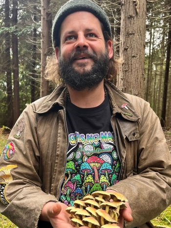 Andy Knott in the New Forest holding sulphur tuft mushrooms